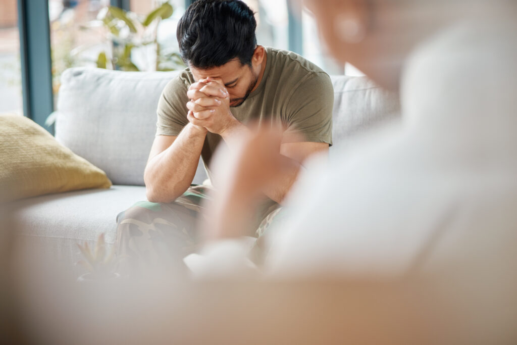 Sad, ptsd and male soldier in therapy for mental health, depression or grief after a military war. Frustrated, trauma and man army warrior talking to a psychologist about emotions in a clinic office.