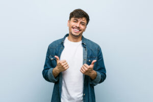 raising both thumbs up, smiling and confident.